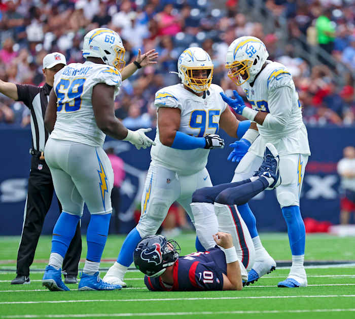 Los Angeles Chargers linebacker Khalil Mack (52) celebrates with Los Angeles Chargers defensive tackle Christian Covington (95) and Los Angeles Chargers defensive tackle Sebastian Joseph-Day (69)